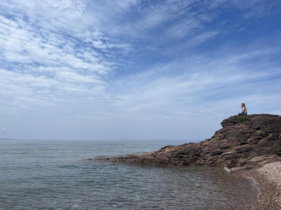 An image of Jason meditating on the shore of Lake Superior.